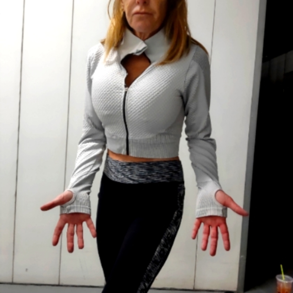 Athletic medium grey jacket with holes for thumbs. The athletic pants are large